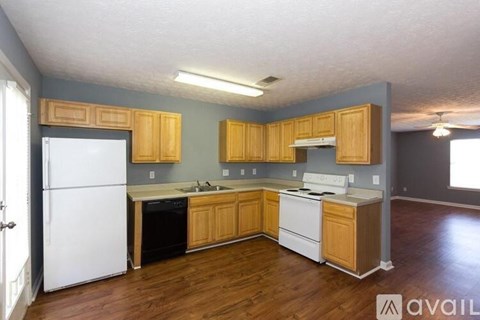A kitchen with wooden cabinets and a white refrigerator.
