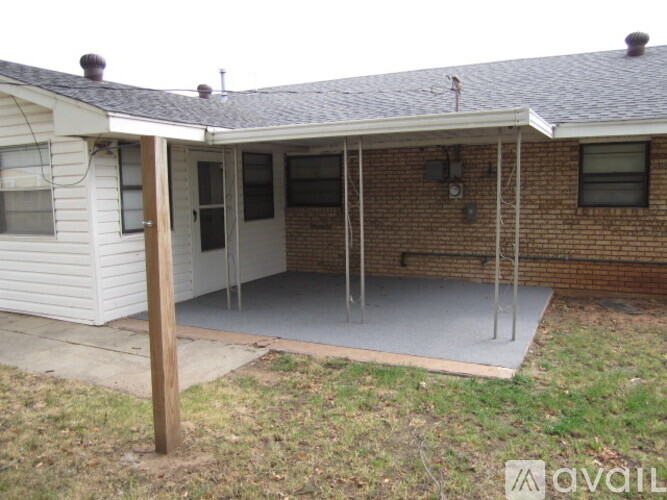 A house with a white exterior and a covered patio area.