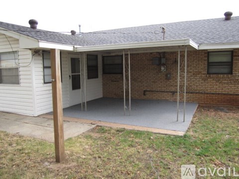 A house with a white exterior and a covered patio area.