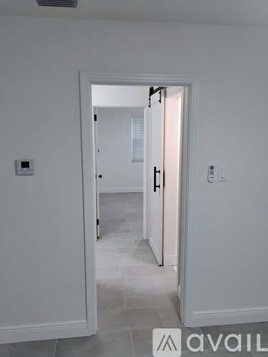 A white doorway leading to another room.