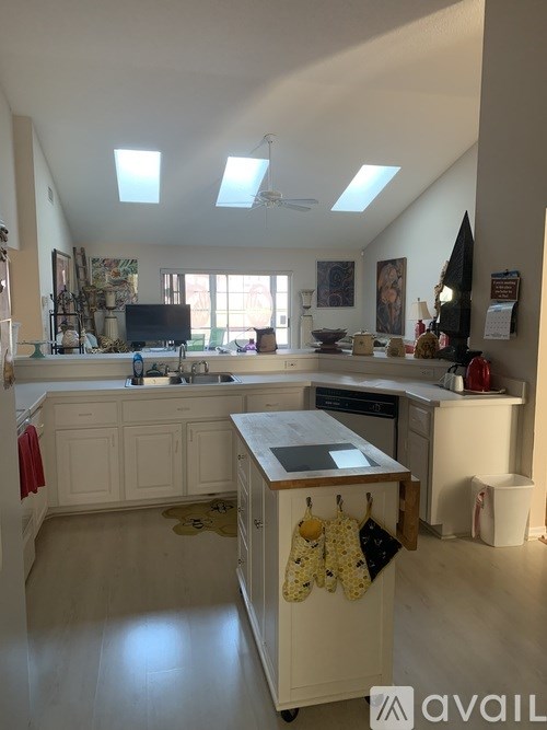 A kitchen with a white cabinet and a sink.
