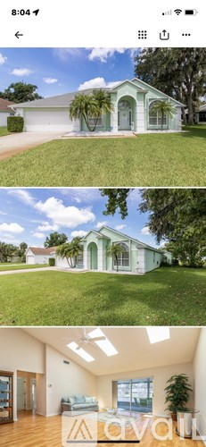 A house with a green door and a white exterior.