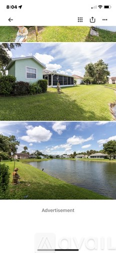 A green house with a blue sky and white clouds in the background.