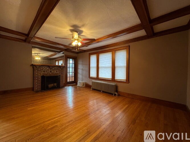 A room with wooden floors and a fireplace.