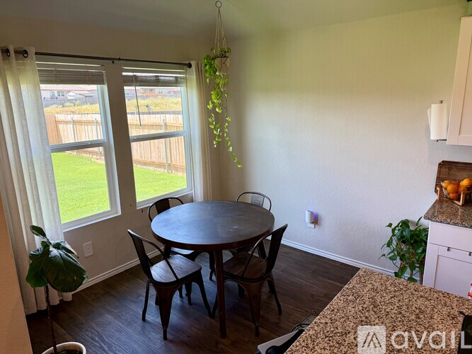 A dining room with a table and chairs.