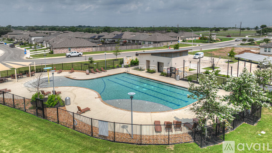 A pool surrounded by a black fence with the word "available" in the bottom right corner.