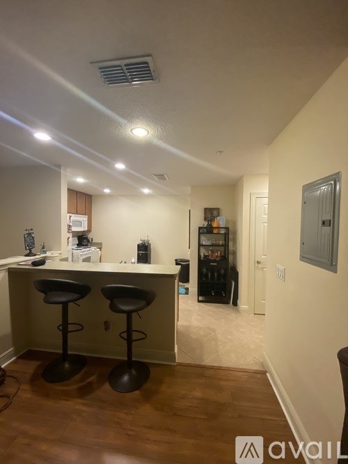A room with a bar and stools.