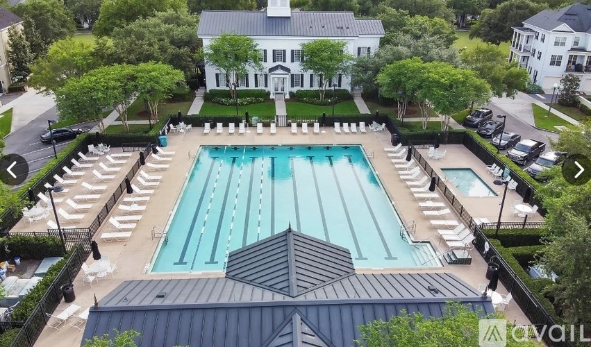 A large swimming pool surrounded by a black fence.