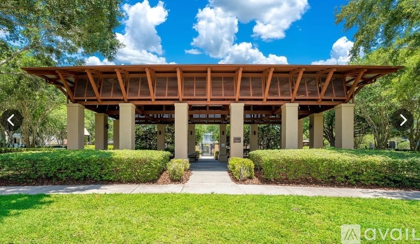 A wooden covered walkway leads to a building entrance.