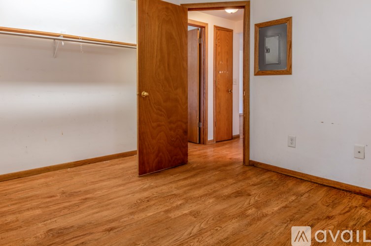A room with a wooden floor and a wooden door.