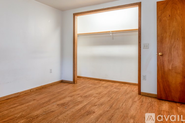 A room with a wooden floor and a wooden door.