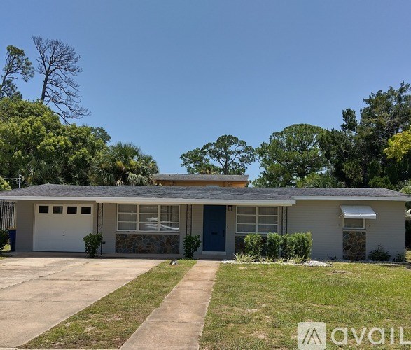 A house with a blue door and a garage.