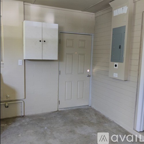 A room with a white door and a white cabinet.