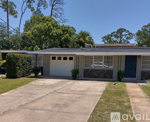 A house with a blue door and a garage.