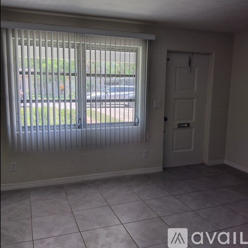 A room with a tiled floor and a sliding door.