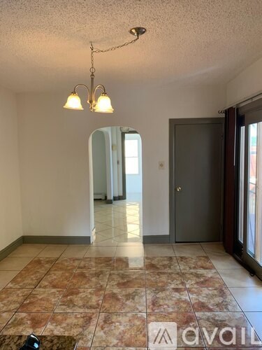 A room with a tiled floor and a chandelier.
