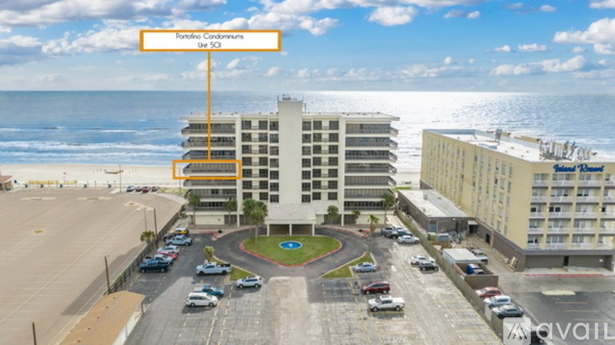 A hotel with a parking lot in front of it.