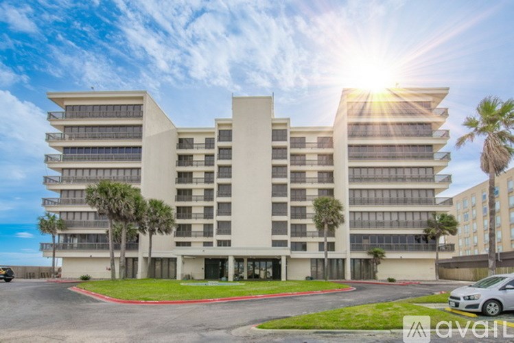 A modern building with a sunny sky in the background.