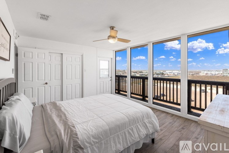 A bedroom with a large bed and a view of the city.