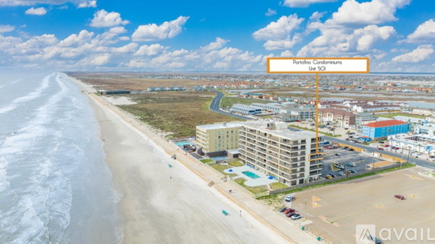 A beachfront area with a sign that reads "Portofino Condominiums".