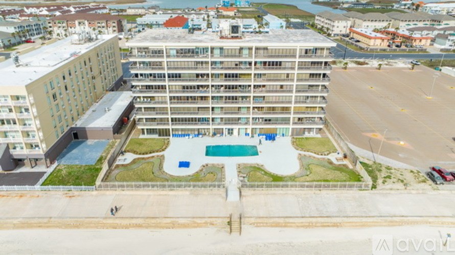 An aerial view of a hotel with a swimming pool.
