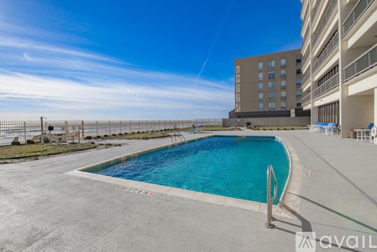 A swimming pool in a sunny outdoor setting.