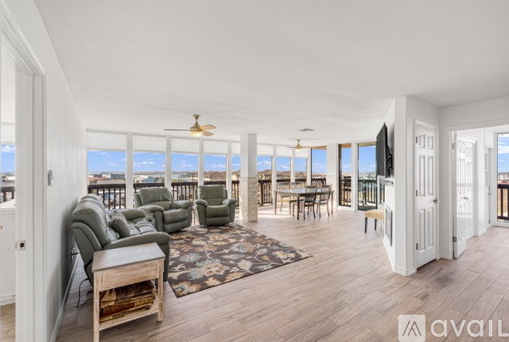 A living room with a view of the ocean.