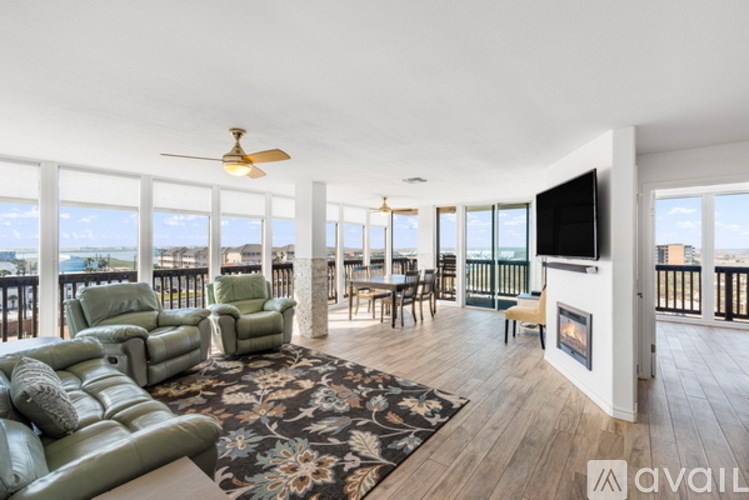 A living room with a green sofa and a television.