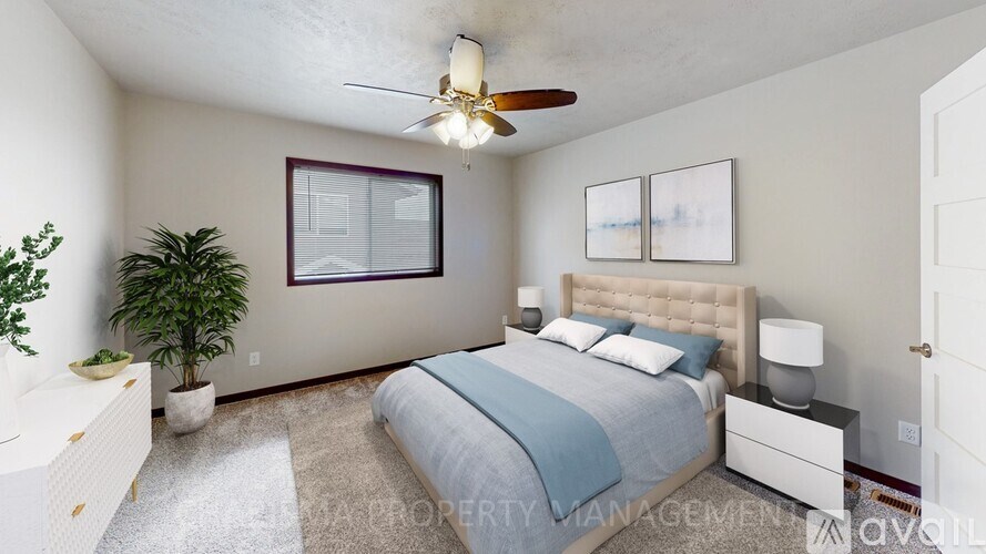 A bedroom with a bed, nightstand, and plant.