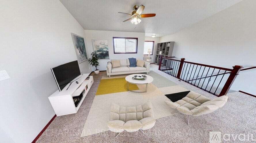 A living room with a television, a couch, and a coffee table.