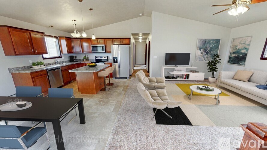 A living room with a black table and a white couch.