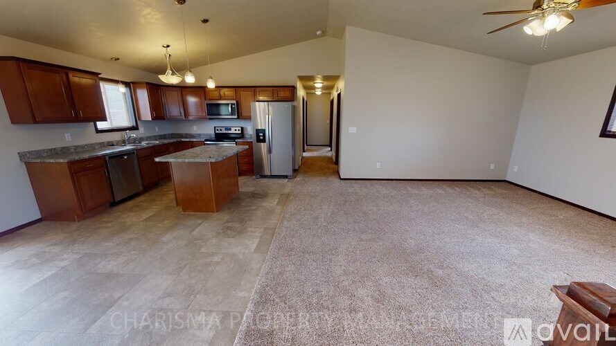A living room with a kitchen area in the background.