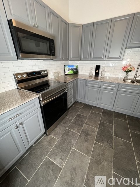 A kitchen with a black oven and microwave.