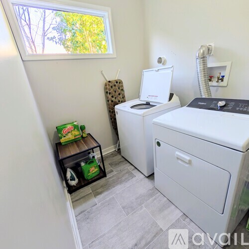 A small laundry room with a washer and dryer.