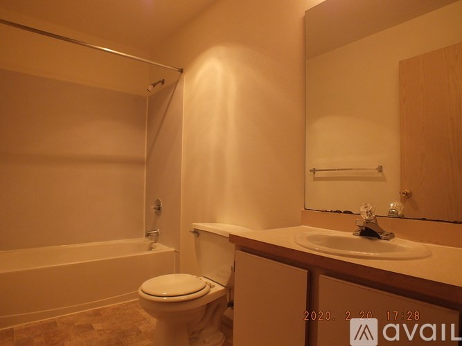 A bathroom with a toilet, sink, and bathtub.