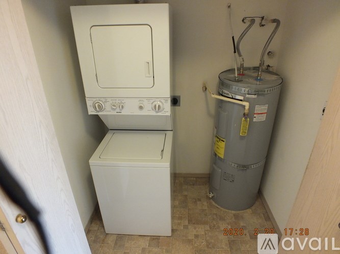 A small white kitchen with a stove and a dishwasher.
