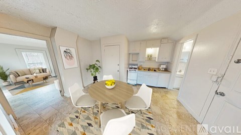 A kitchen with a table and chairs in the middle of the room.