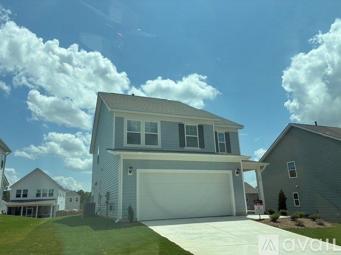 A house with a garage is for sale.