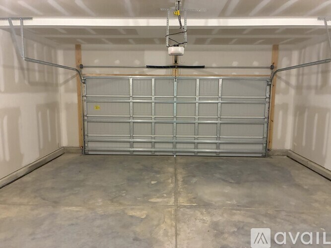 A large metal gate is the only thing separating the viewer from a storage unit.