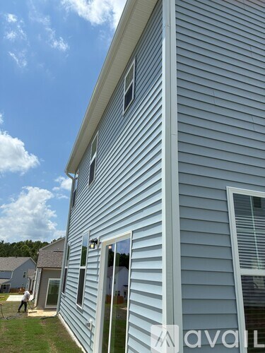 A house with a blue siding and a window on the side.