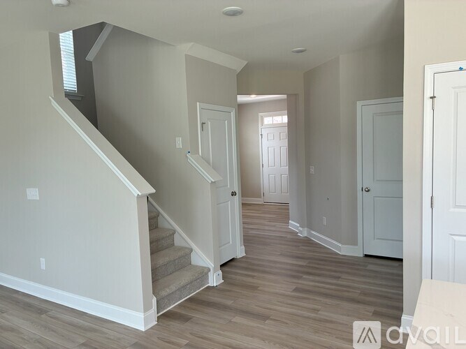 A room with a staircase and a door.