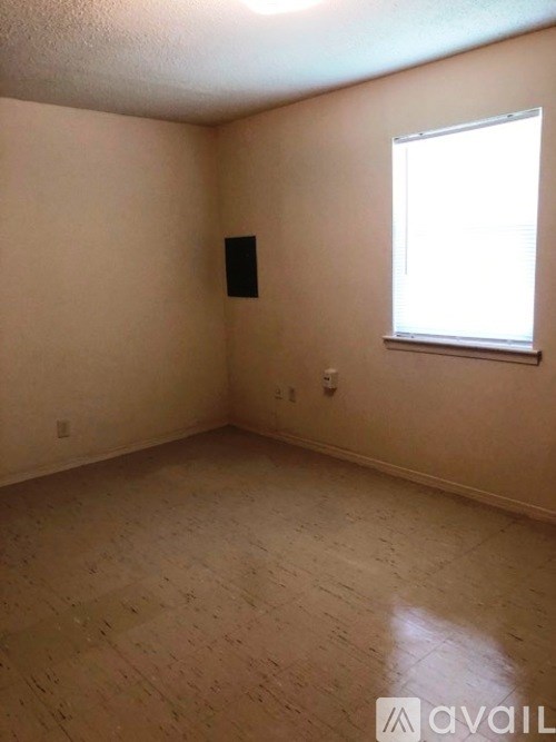 A room with a window and a door on the wall.