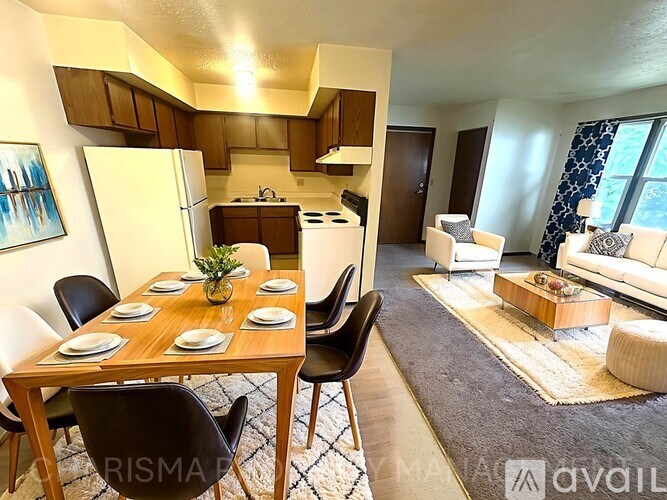 A well-lit kitchen and dining area with a table set for a meal.