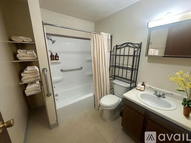 A bathroom with a toilet, sink, and bathtub.