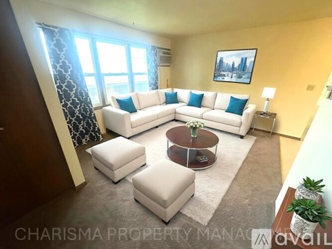 A living room with a white sofa set and a coffee table.