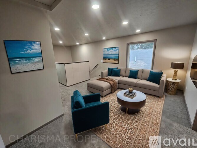 A living room with a blue couch, a white sofa, and a coffee table.