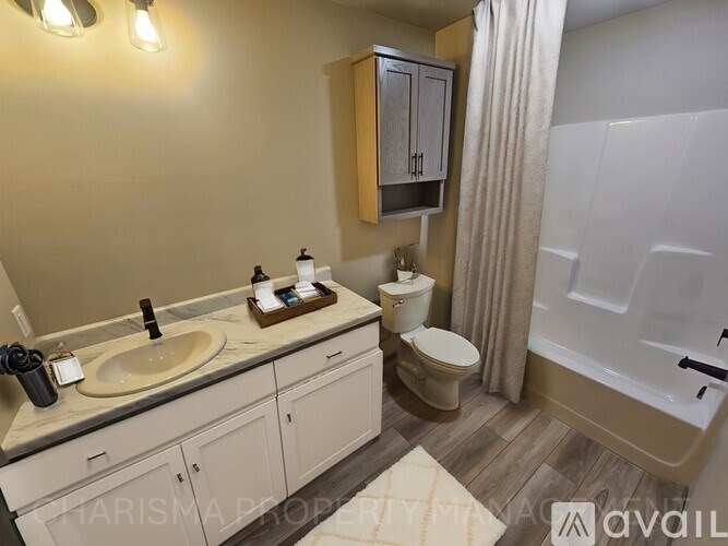 A bathroom with a sink, toilet, and bathtub.