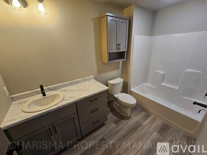 A bathroom with a sink, toilet, and bathtub.