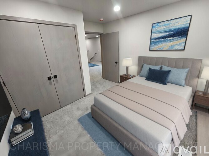 A bedroom with a large bed and a painting on the wall.