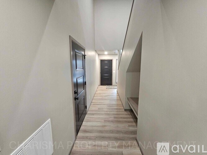 A long hallway with a door at the end.